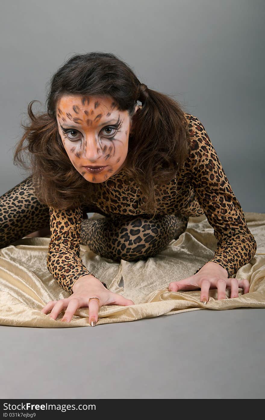 Portrait of girl with leopard's face-art in the studio