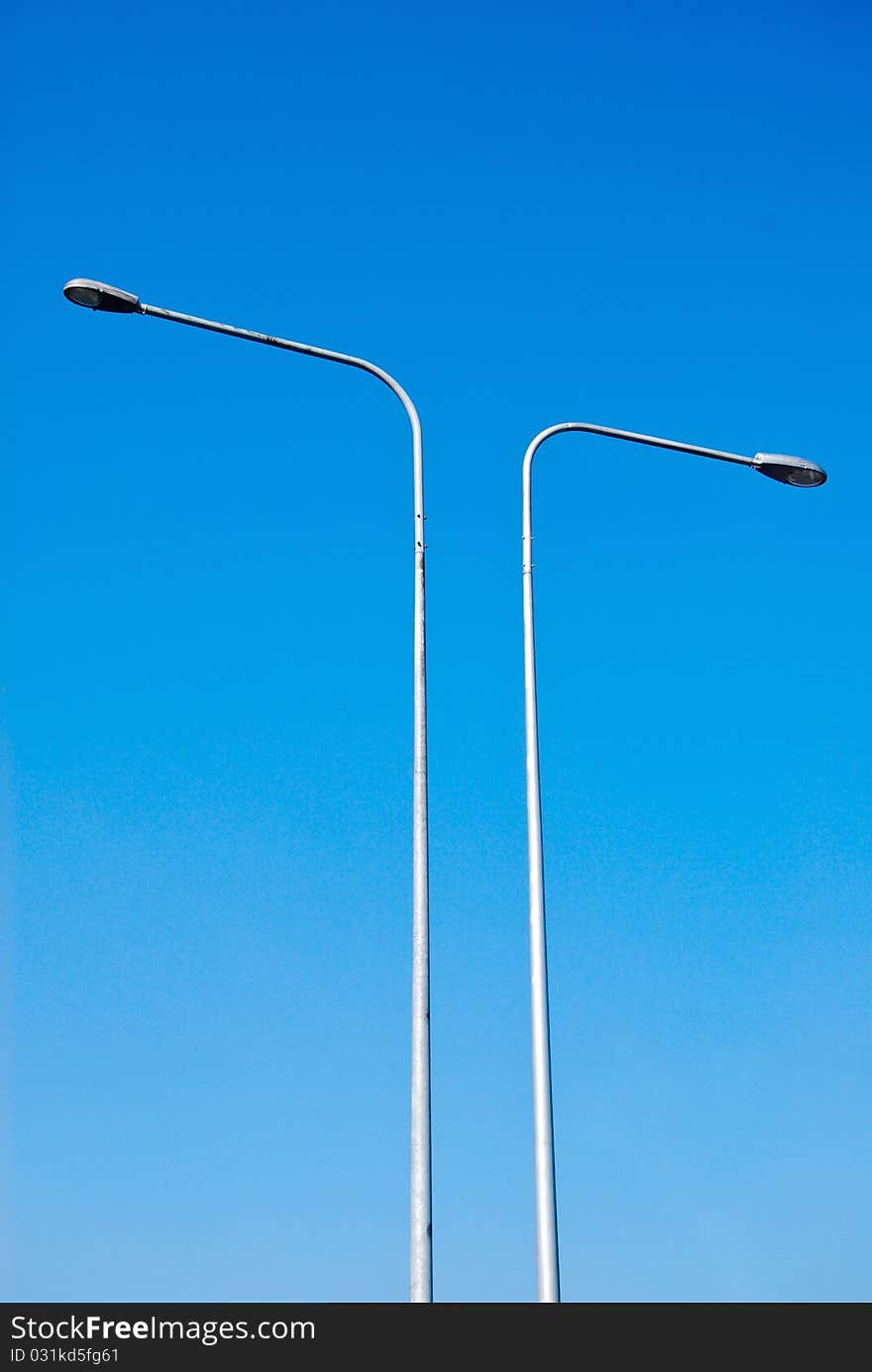 Electricity lamp post on the blue sky background