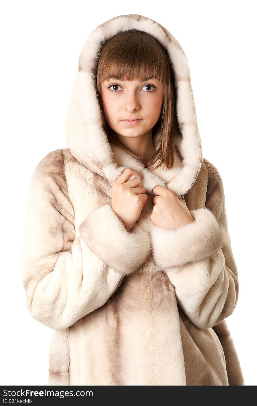 A beautiful young girl in a fur coat