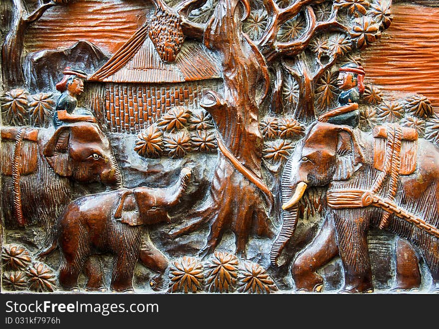 Farmer and elephant wood carving background