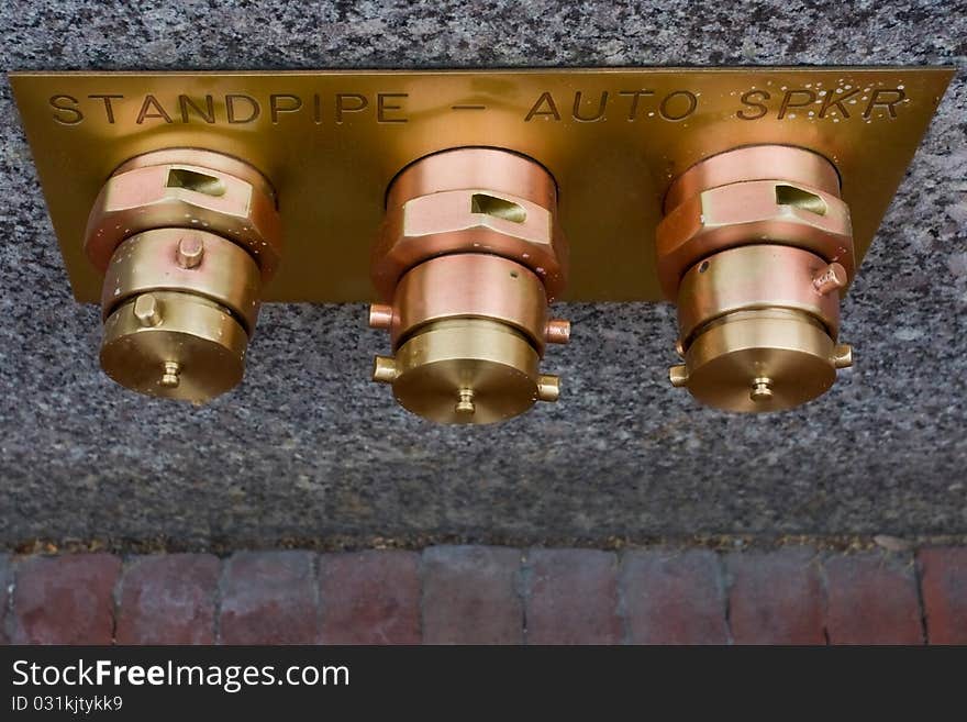 Three street copper hydrants on wall. Three street copper hydrants on wall