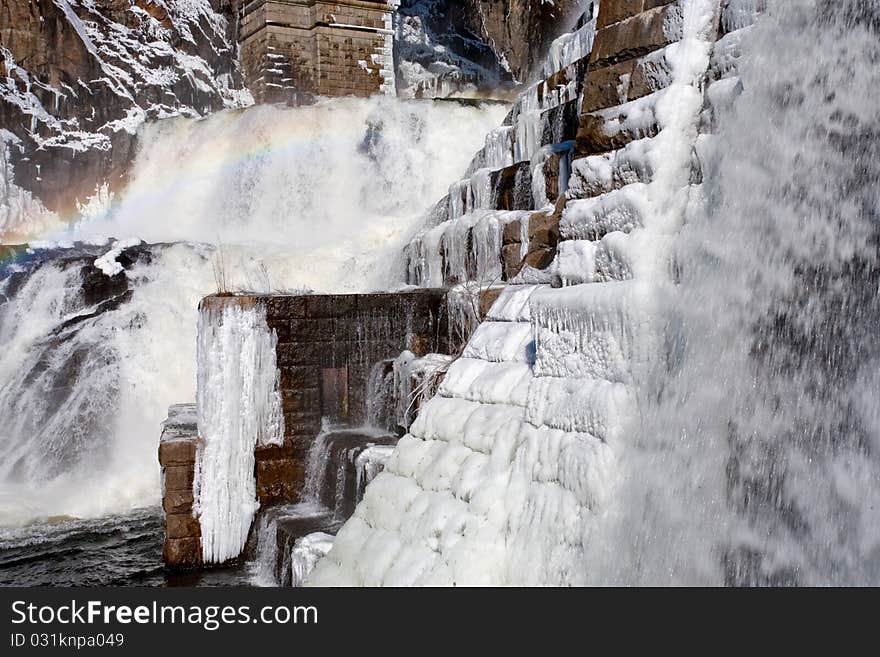 Rainbow on frozen water cascade. Rainbow on frozen water cascade