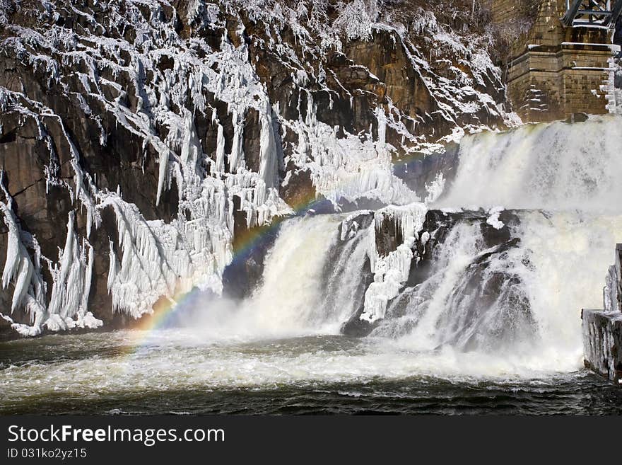 Rainbow on frozrn water cascade. Rainbow on frozrn water cascade