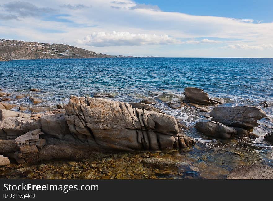 Rocks and stones at the blue sea in the surf ... Greece.