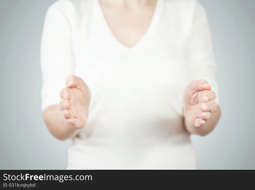 Woman's hands open. isolated on grey background