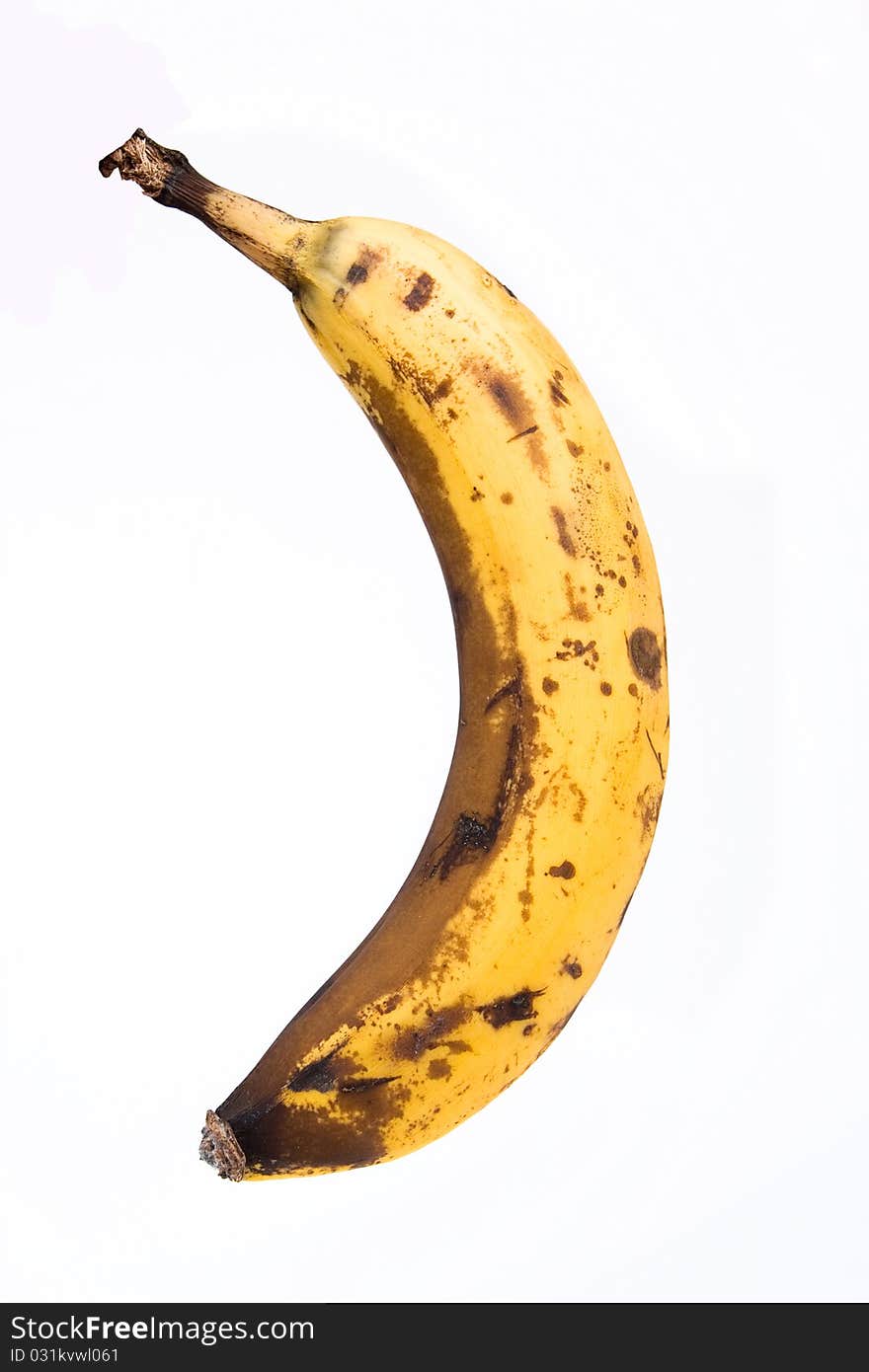 Banana with brown spots isolated over white background