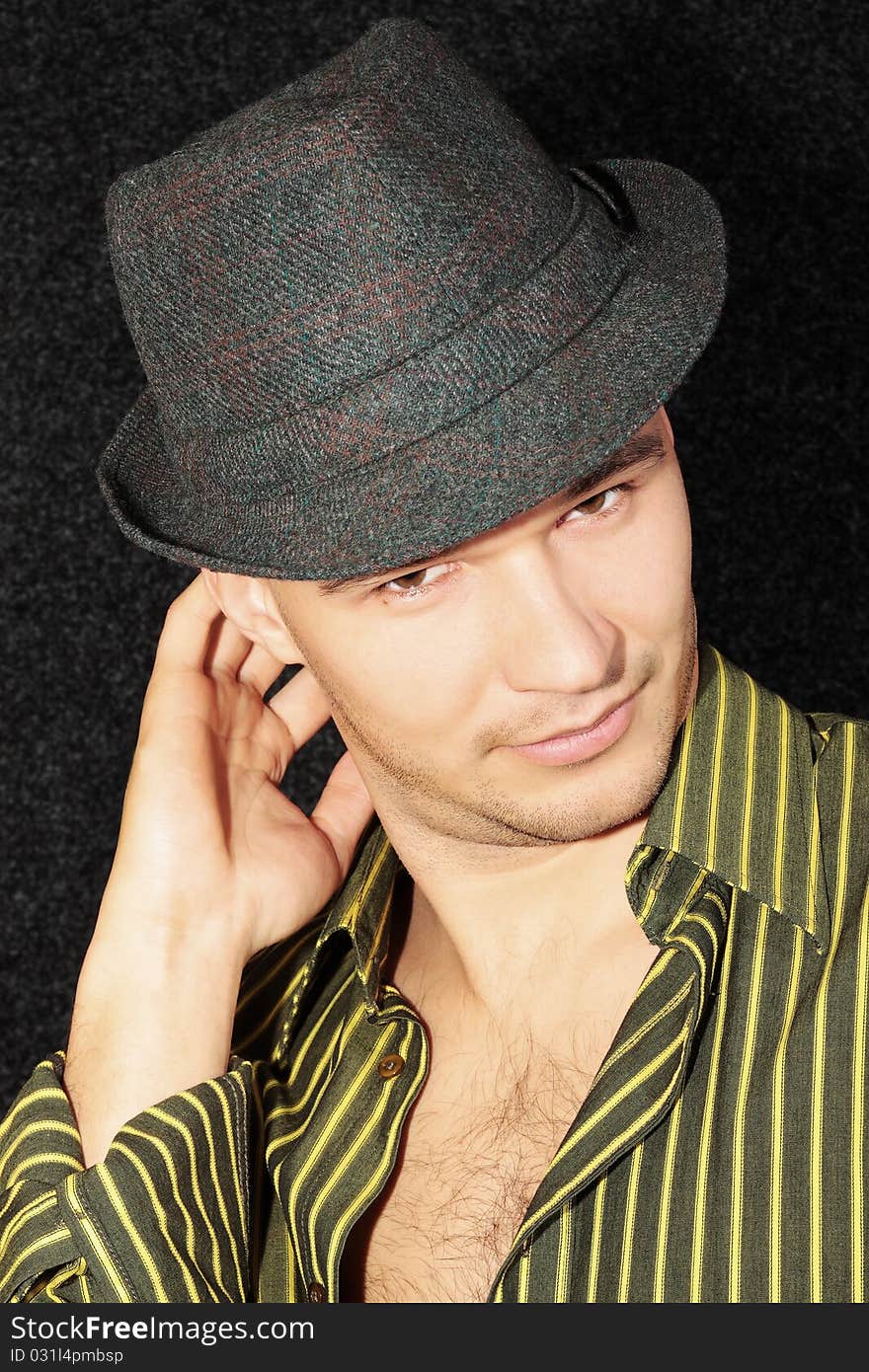 Portrait of young beautiful man in the hat