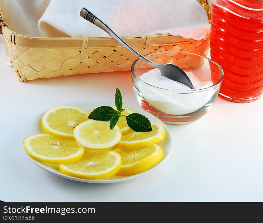 Cherry juice in a glass with a lemon on a white background. Cherry juice in a glass with a lemon on a white background