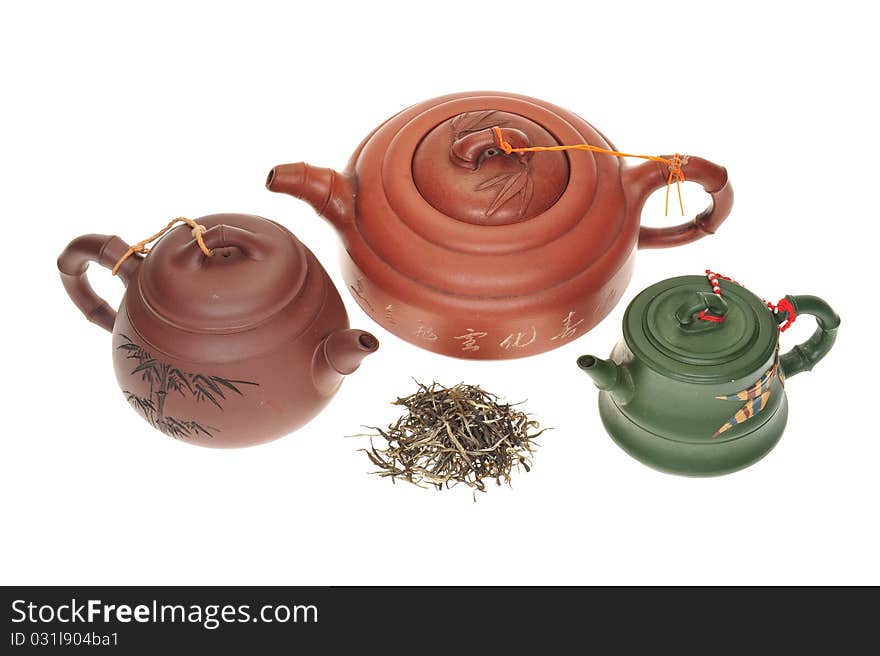 Chinese Clay Teapots With Dried tea Leaves On A White Background. Chinese Clay Teapots With Dried tea Leaves On A White Background