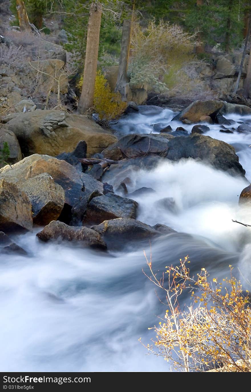 Artistic creamy river rapids with rocks. Artistic creamy river rapids with rocks