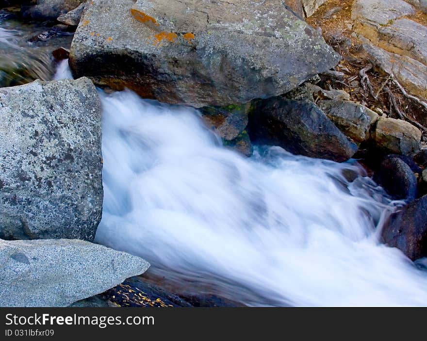 Artistic creamy river rapids with rocks. Artistic creamy river rapids with rocks