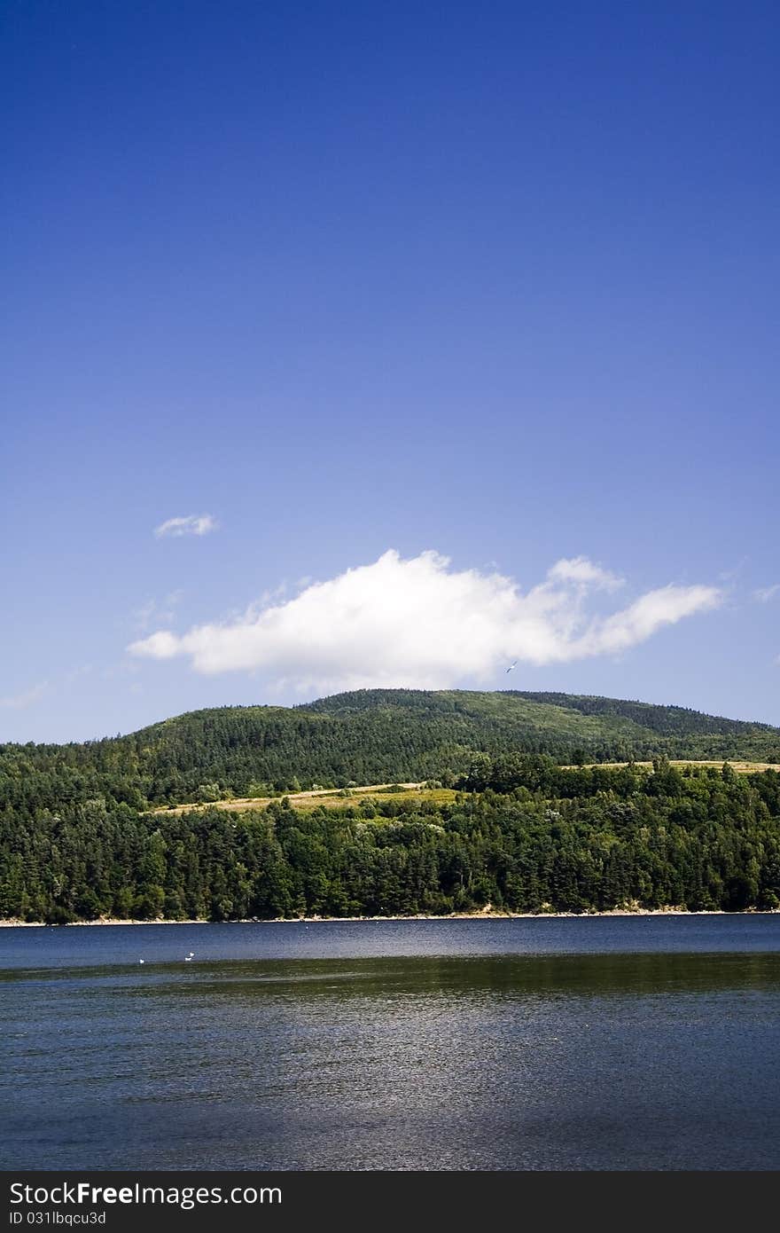 Beautiful lake located between the mountains on which you can sail. Beautiful lake located between the mountains on which you can sail.