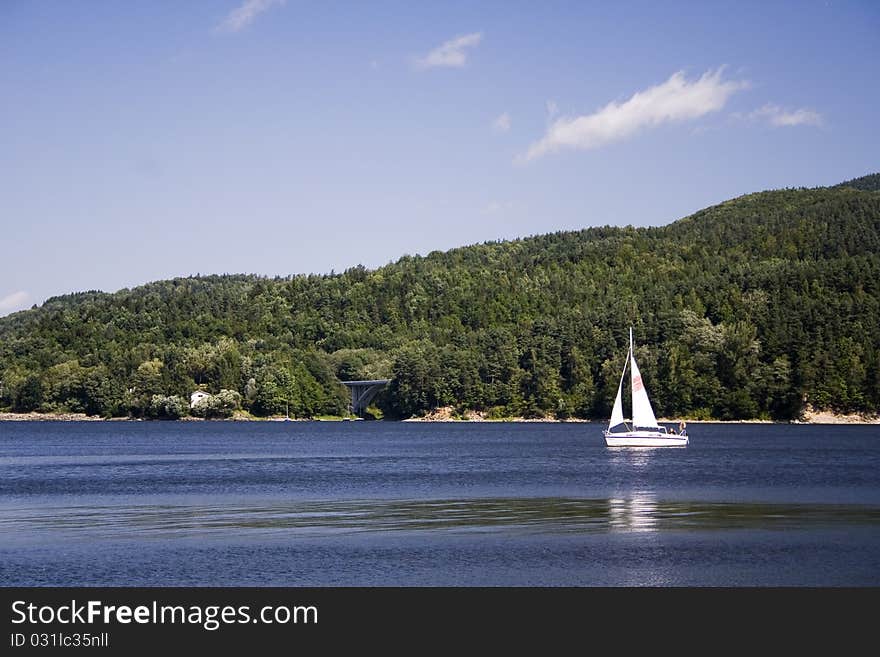 Beautiful lake located between the mountains on which you can sail. Beautiful lake located between the mountains on which you can sail.