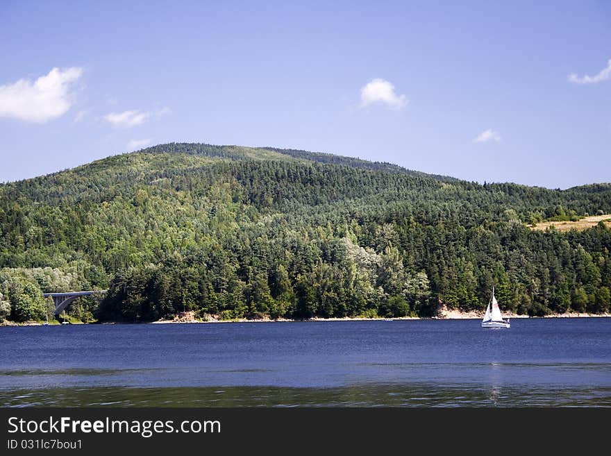 Beautiful lake located between the mountains on which you can sail. Beautiful lake located between the mountains on which you can sail.