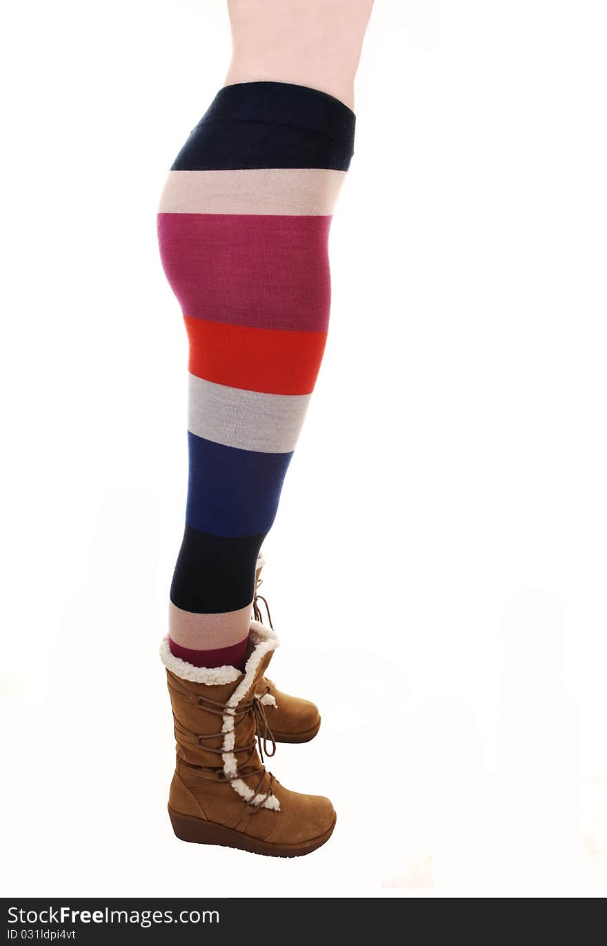 A young woman in a colorful pantyhose and brown boots standing in profile, showing her nice figure, for white background. A young woman in a colorful pantyhose and brown boots standing in profile, showing her nice figure, for white background.