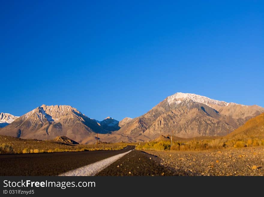 Road leads to snow peaked Mountains. Road leads to snow peaked Mountains