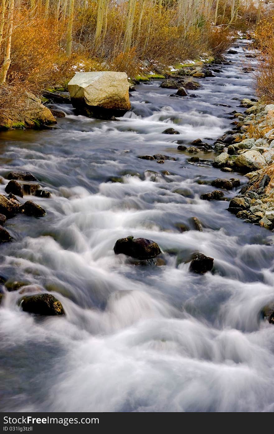 Artistic creamy river rapids with rocks. Artistic creamy river rapids with rocks