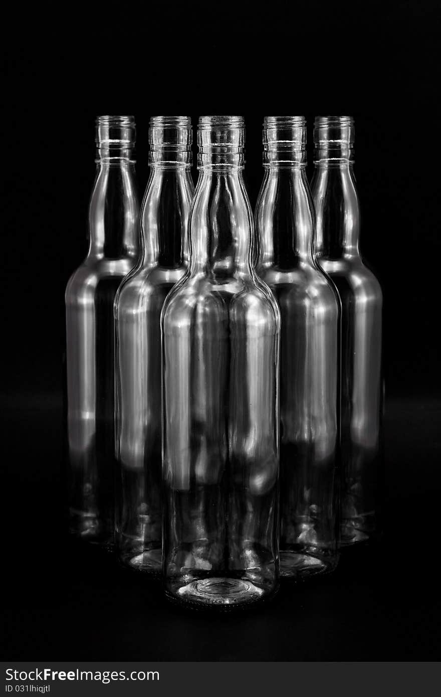 Empty bottles collection, colorless, isolated on black backgrounde