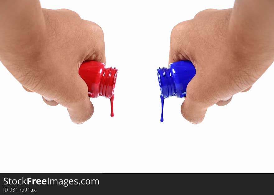 Both hands pouring blue and red water colors all at once. Both hands pouring blue and red water colors all at once