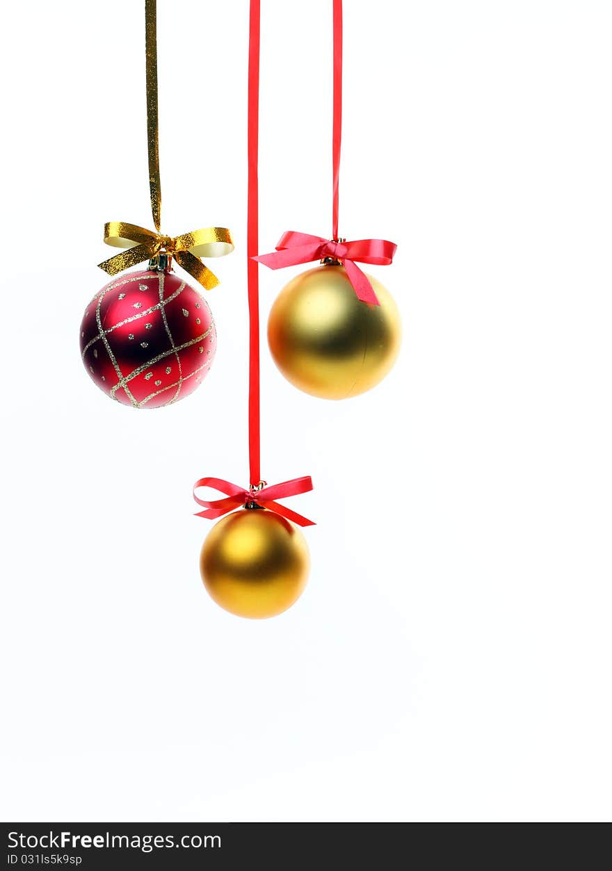 Christmas balls hanging with ribbons on white background