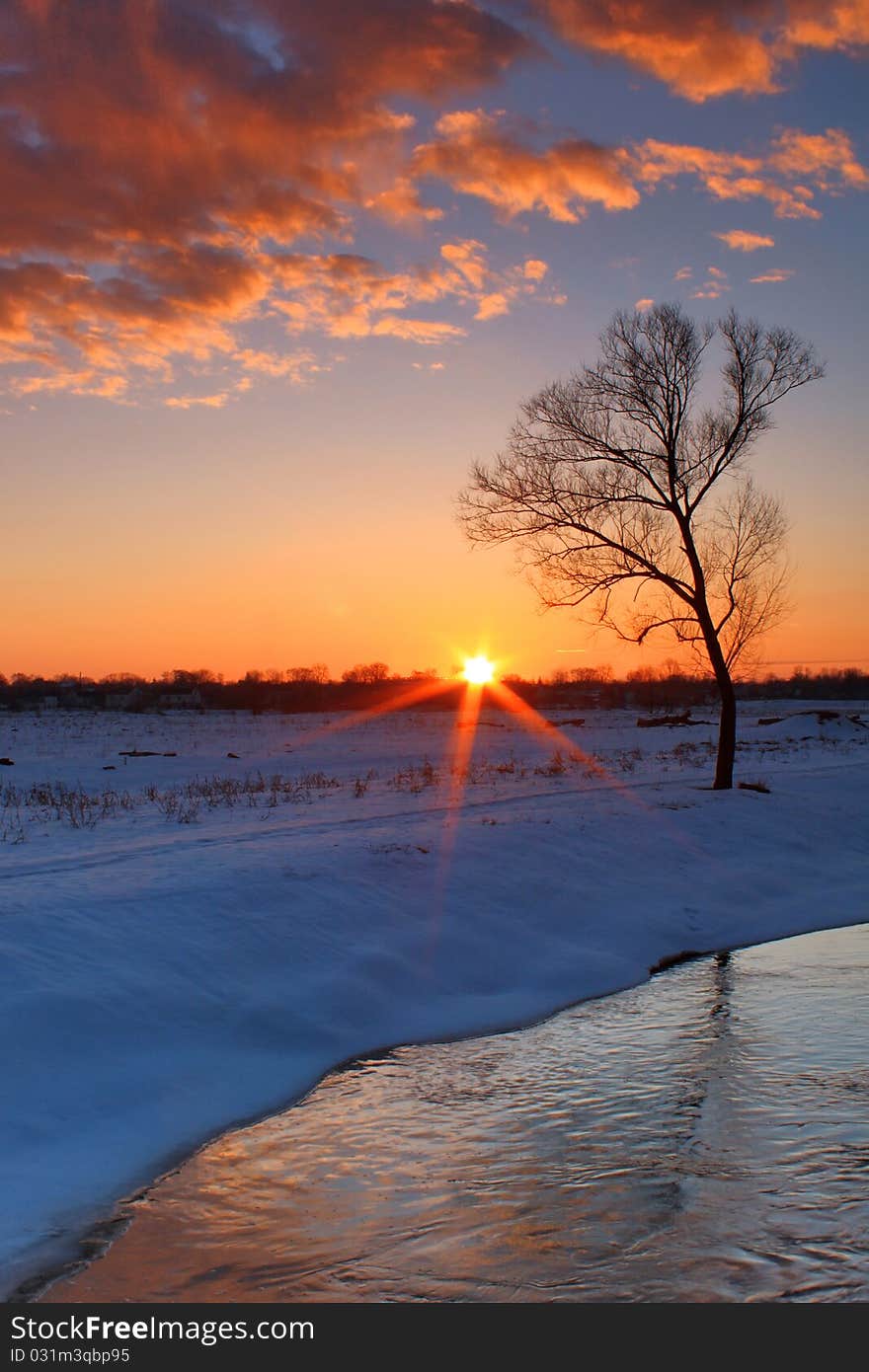 A colorful sunrise over the river winter morning. A colorful sunrise over the river winter morning