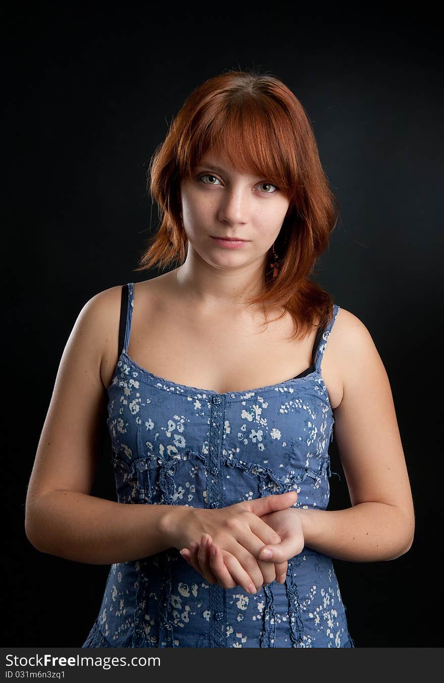 Portrait of girl with her red hair looking at the camera