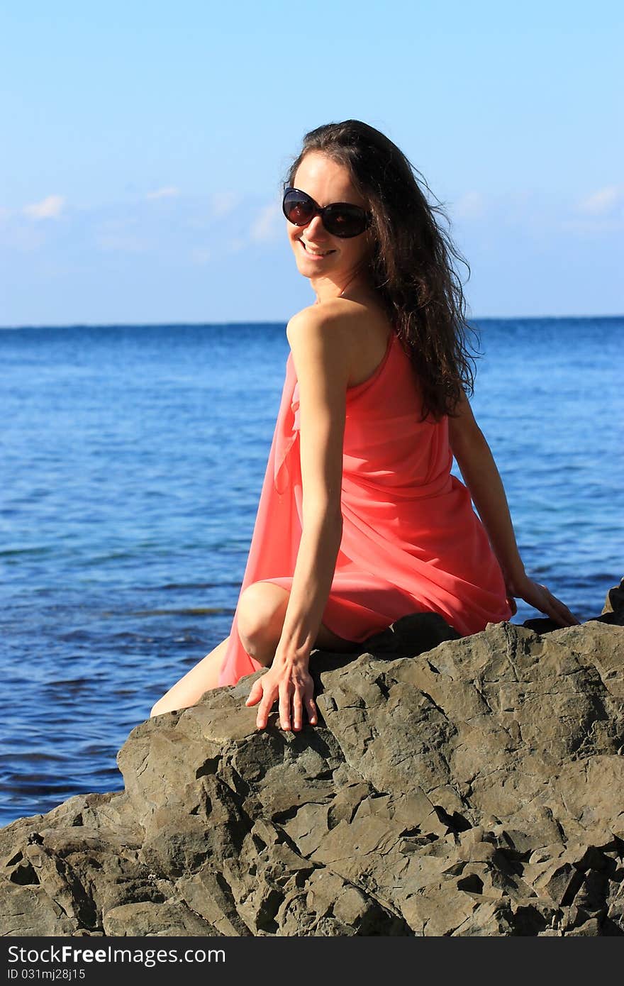 Attractive young woman enjoying summer vacation on the seashore