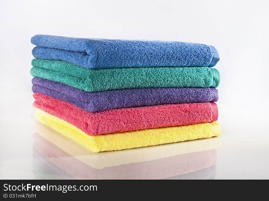 Bath towels against a white background in a studio environment. Bath towels against a white background in a studio environment