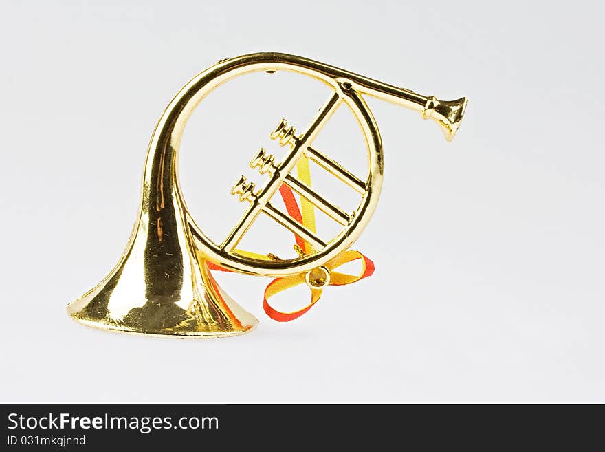 Christmas trumpet on red background