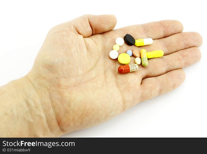 Tablets on a hand on a white background. Tablets on a hand on a white background.