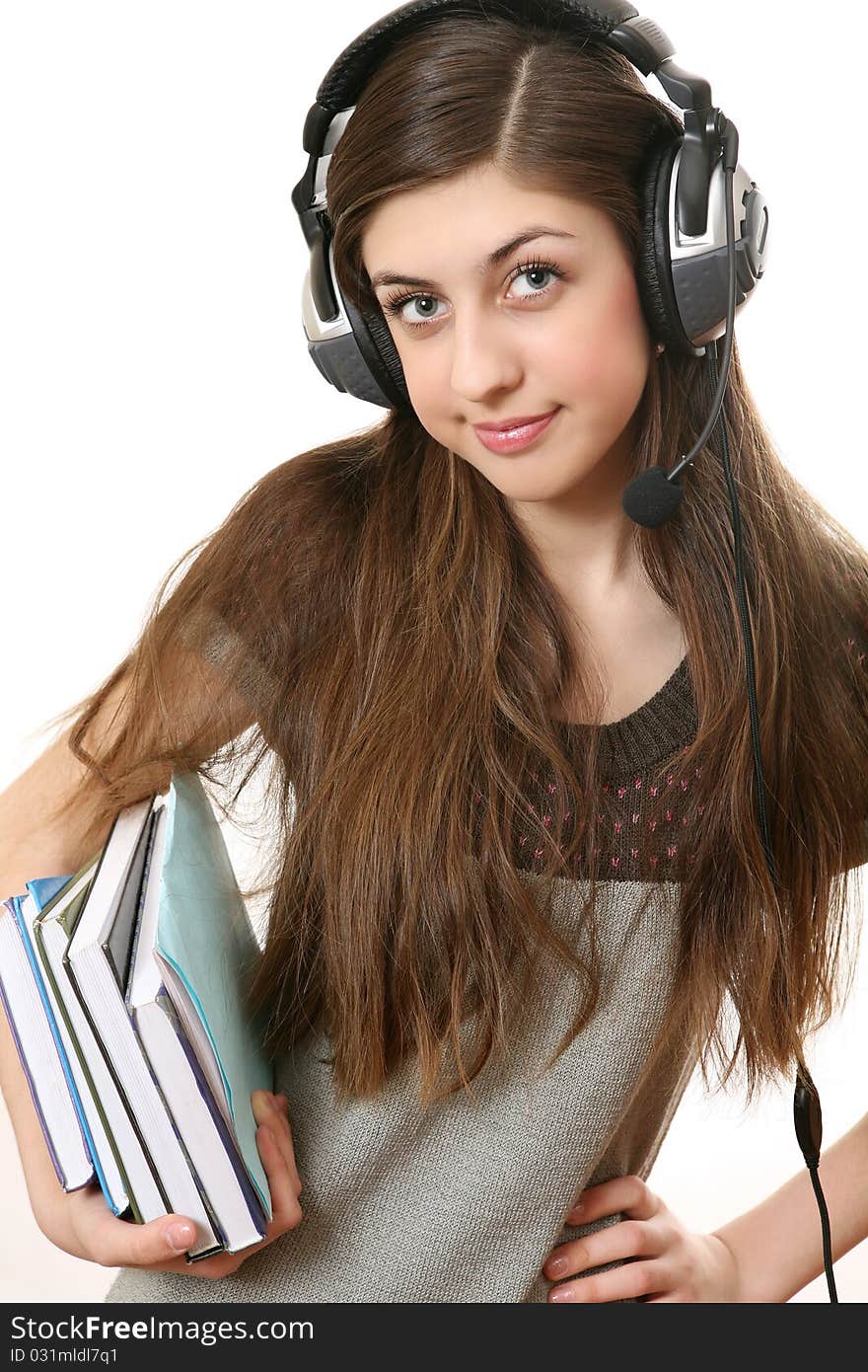 The girl in headphones with books