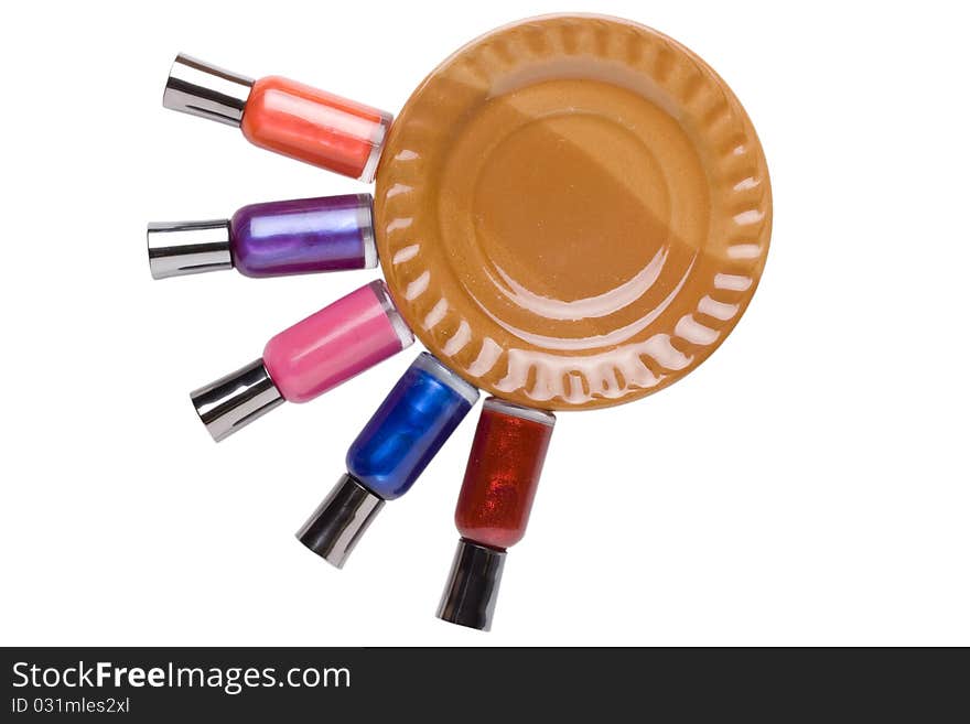 Nail polish bottles neatly placed around a brown plate.