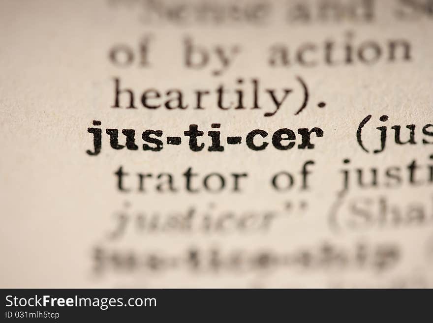 Word justicer from the old dictionary, a close up.