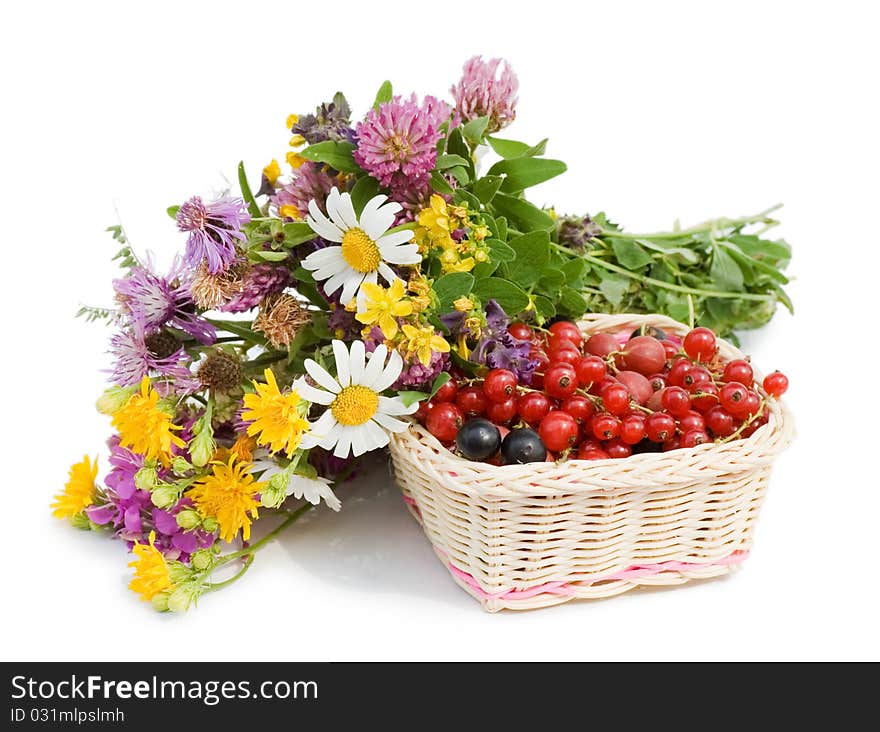 Ripe berries in a basket and flowers