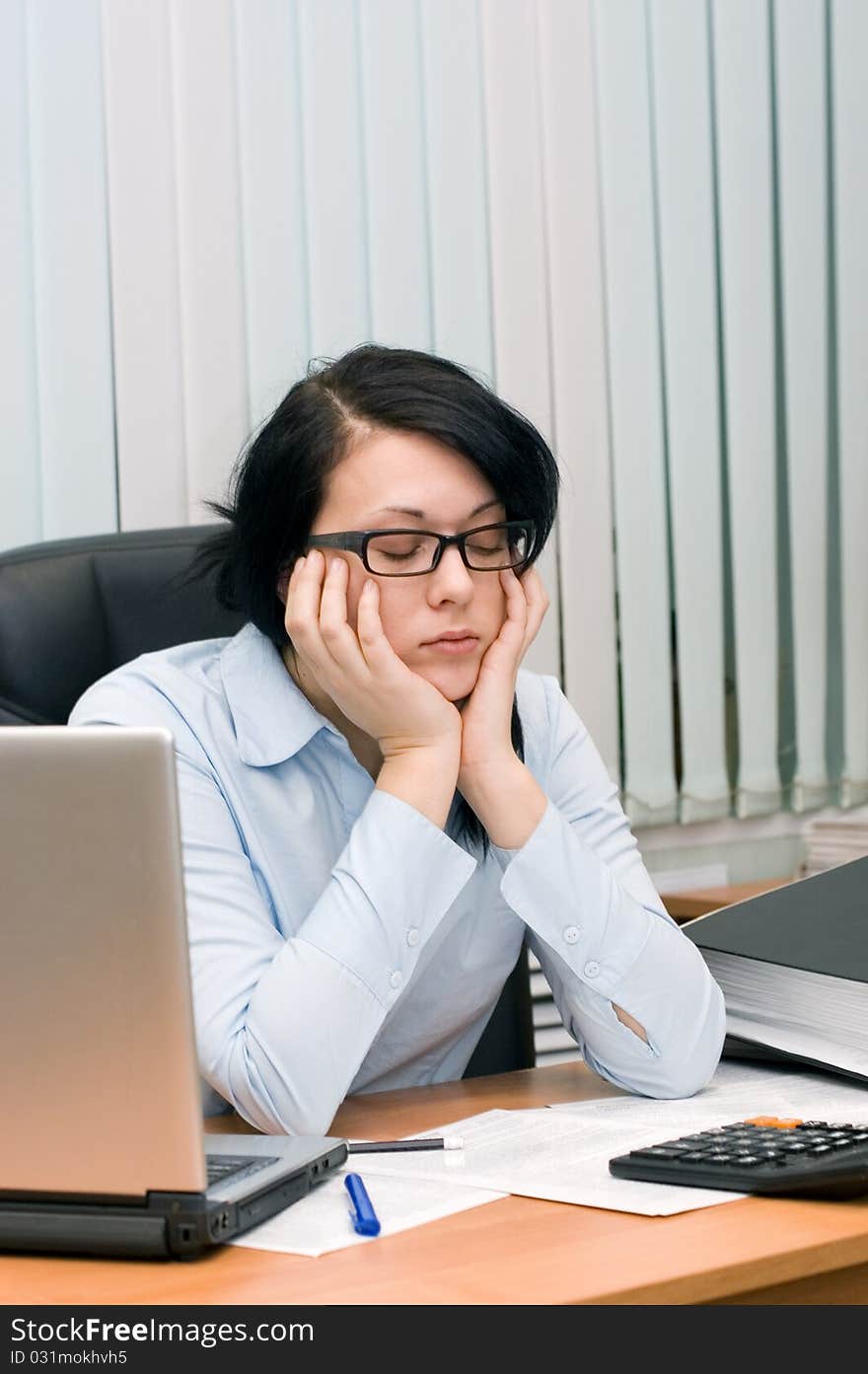 Young girl at office behind a table