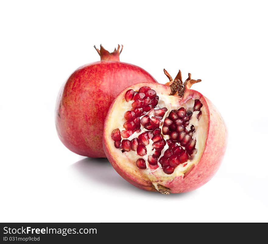 Juicy opened pomegranate on white backgrounds