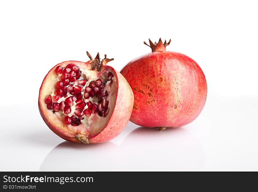 Juicy opened pomegranate on white background