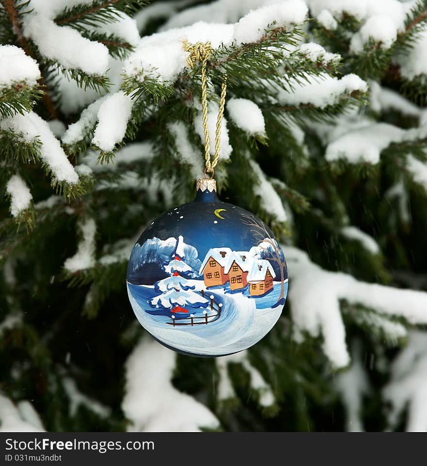 New Year's sphere on a snow-covered fur-tree