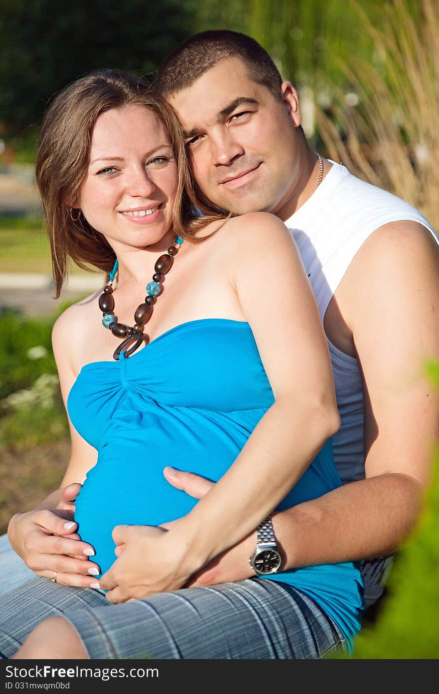 Happy husband embracing pregnant wife