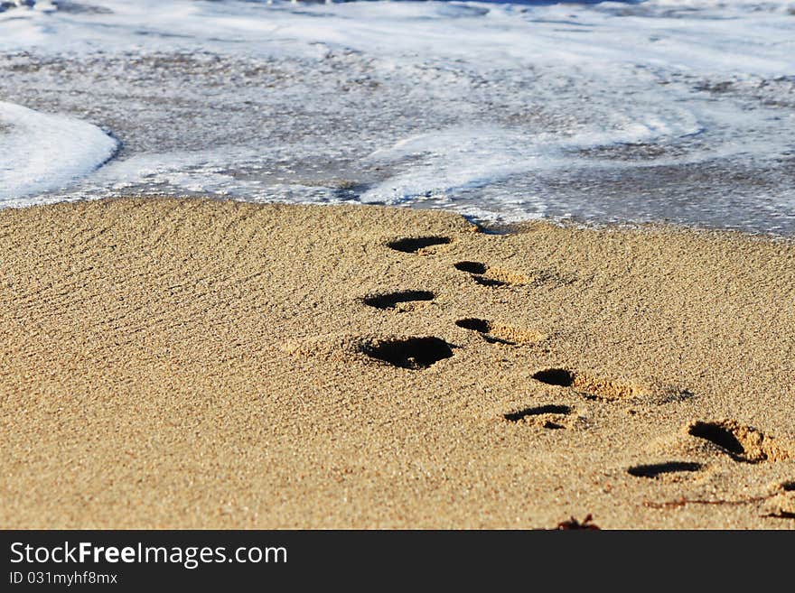 California beach, footprints going to the ocean. California beach, footprints going to the ocean