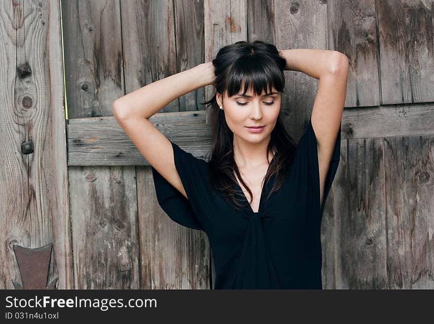 Young beautiful girl the brunette, holds hair