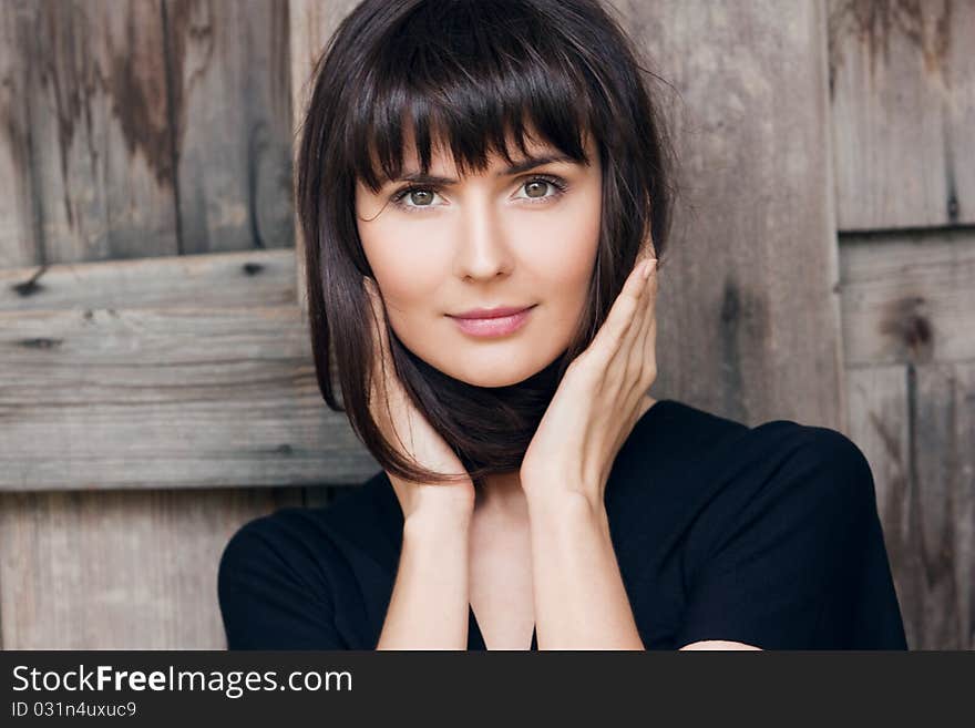 Young beautiful girl holds hair