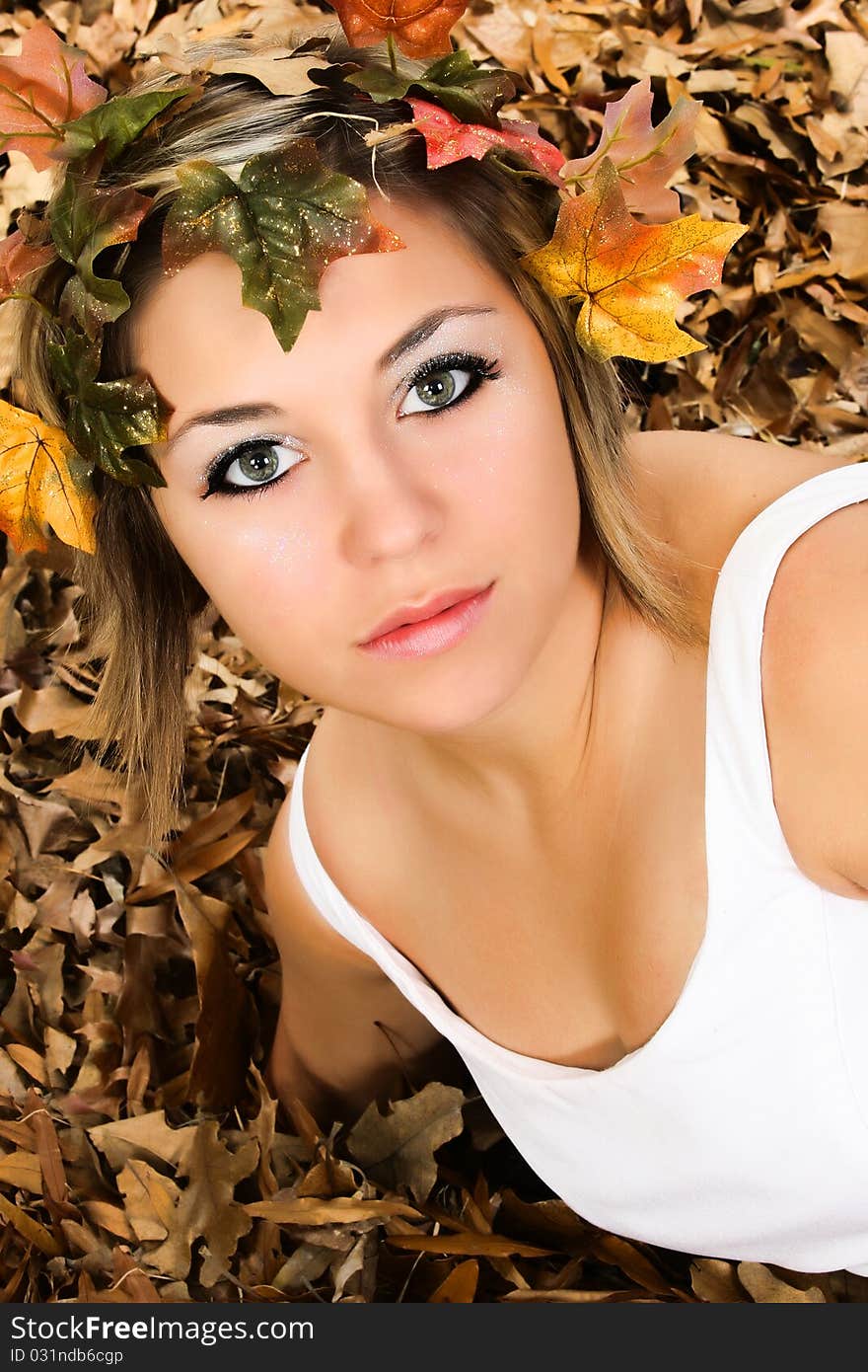 Beautiful young woman in fall colored leaves close up portrait. Beautiful young woman in fall colored leaves close up portrait.