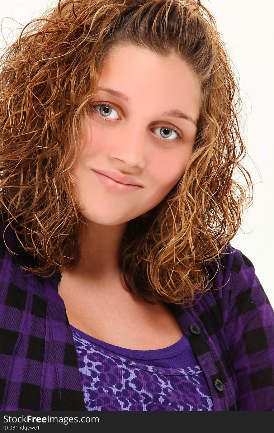 Beautiful 13 year old teen girl smiling over white background.