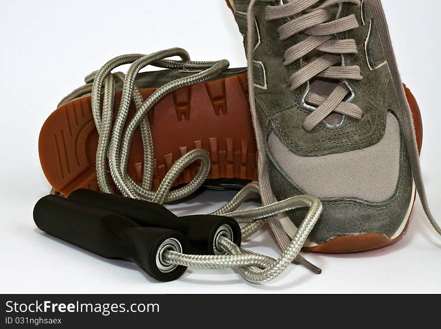 Sneakers and skipping rope on a white background. Sneakers and skipping rope on a white background