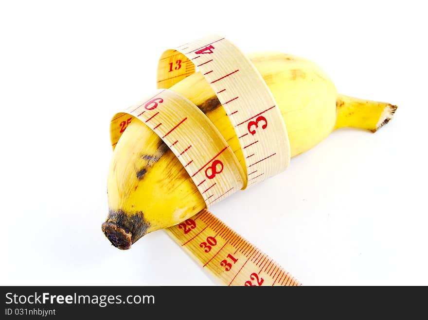 Diet banana with measuring tape isolated on white background. Diet banana with measuring tape isolated on white background