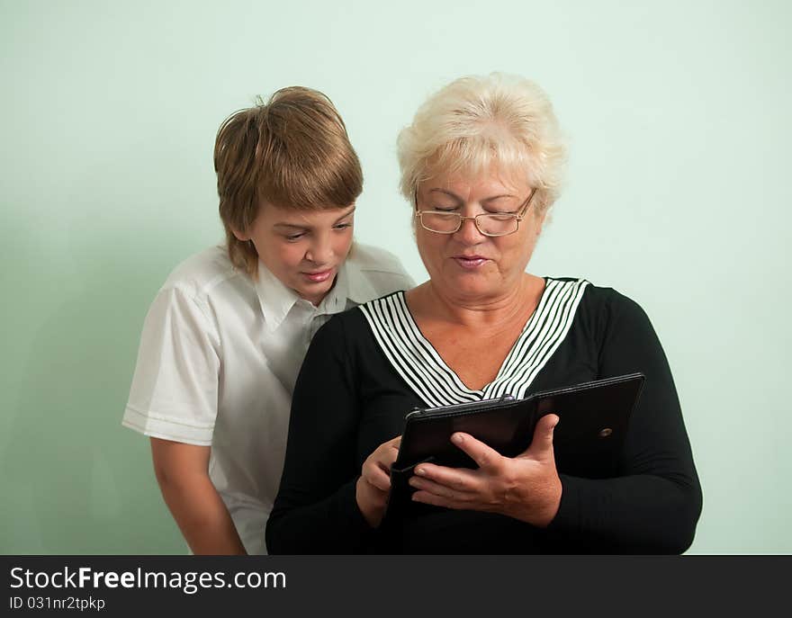 Grandmother and her grandson, read e-books. Grandmother and her grandson, read e-books.