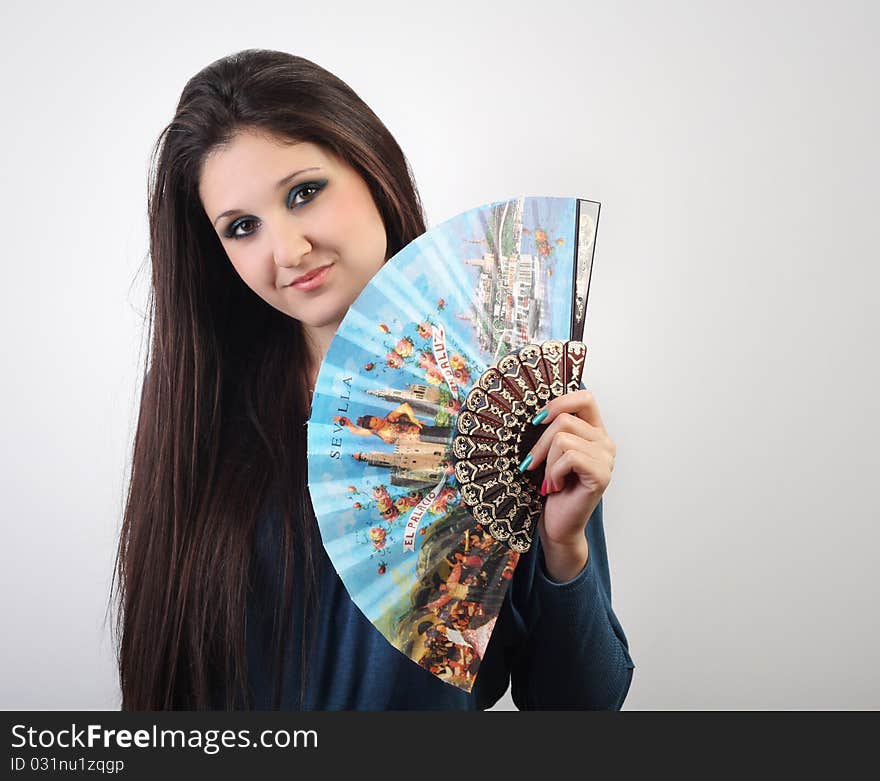 Beautiful Young Woman With A Fan In Her Hand