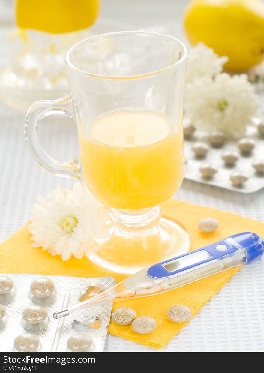 Hot drink with thermometer and pills