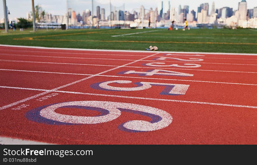 Shot of a running track and New York City skyline in the background. Shot of a running track and New York City skyline in the background